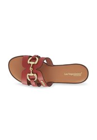 Sandale à glissière en cuir rouge avec une large sangle, dotée de deux boucles dorées et d'une semelle intérieure rembourrée marron.