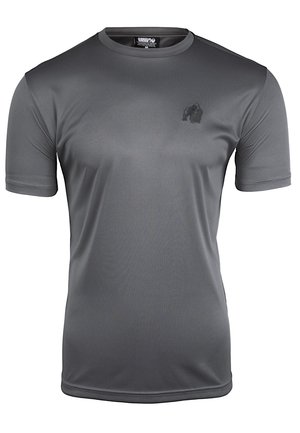 T-shirt de sport à manches courtes grise fabriquée en tissu lisse et évacuant l'humidité. Présente un petit logo noir sur la poitrine.