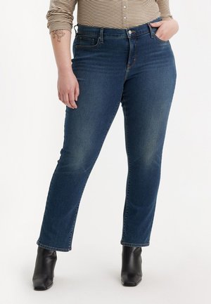 Donkerblauwe spijkerbroek van denim, met een rechte pijpdesign, vijf zakken en subtiele vervaging. Gepaard met zwarte enkellaarsjes.