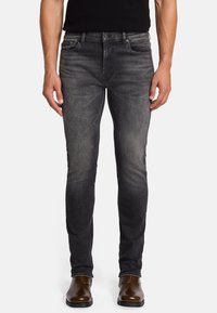 Schmale, dunkelgraue Jeans aus Denim mit einem verblassten Finish, Fünf-Taschen-Design, Metallknopfverschluss und Stickakzenten entlang der Nähte.