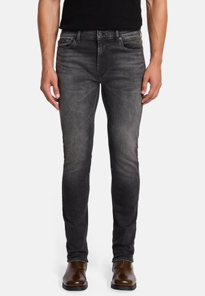 Slim-fit, dark gray denim jeans with a faded finish, five-pocket design, metal button closure, and stitching accents along the seams.