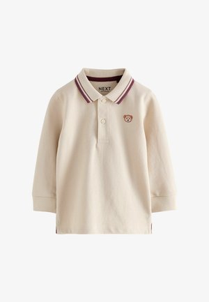 Kreemi värvi pikade varrukatega polo särk, mis on valmistatud puuvillast, burgundia punase triibulise krae ja väikese karupoja tikandiga rinnal.