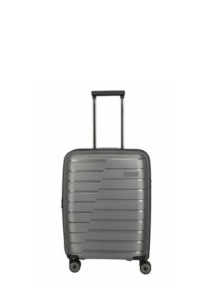 Gray hard-shell suitcase with horizontal ridges, telescopic handle, and four 360-degree spinner wheels.