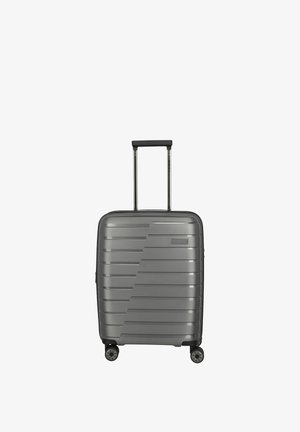 Gray hard-shell suitcase with horizontal ridges, telescopic handle, and four 360-degree spinner wheels.