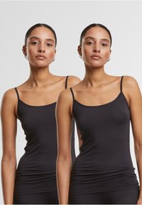 Black camisole top with thin straps. Soft, stretchy fabric with a fitted design and a smooth texture. Features a rounded neckline and seamless edges.