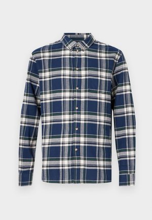 Pledēta krekls tumši zilā, zaļā un baltā krāsā. Garas piedurknes, apkakle ar pogām, priekšējās pogas un kreisās krūšu kabatas. Kokvilnas audums.