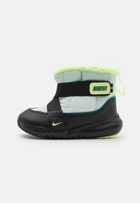Black and light blue winter boot with a green fur lining, adjustable black strap, and neon yellow accents; rubber sole with grip.