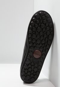 Black rubber shoe sole featuring a textured pattern of raised circles, with embossed "Camper" logo and size "41" in the center.