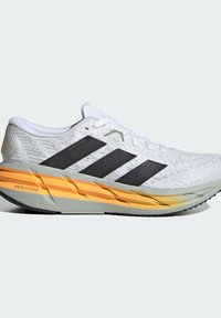 White running shoe with black three stripes, textured upper, and a gradient midsole featuring orange and gray accents. Rubber outsole.