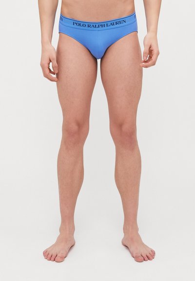 Blaue Baumwollunterhose mit einfarbigem Design, ausgestattet mit einem schwarzen Bund mit dem "POLO RALPH LAUREN" Logo; eng anliegende Passform mit minimaler Bedeckung.