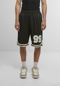 Black athletic shorts with white accents, featuring the number "99" in bold on the left leg. Elastic waistband and side stripes. Casual fit.
