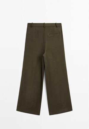 Pantalons larges en lin vert olive foncé. Présente un design minimaliste, des passants de ceinture et une poche arrière unique. Texture lisse.