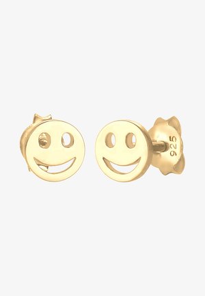 Orecchini a monachella a forma di faccina sorridente in tonalità oro, di forma rotonda con caratteristiche ritagliate, e un retro testurizzato. Dimensione adatta per un uso versatile.