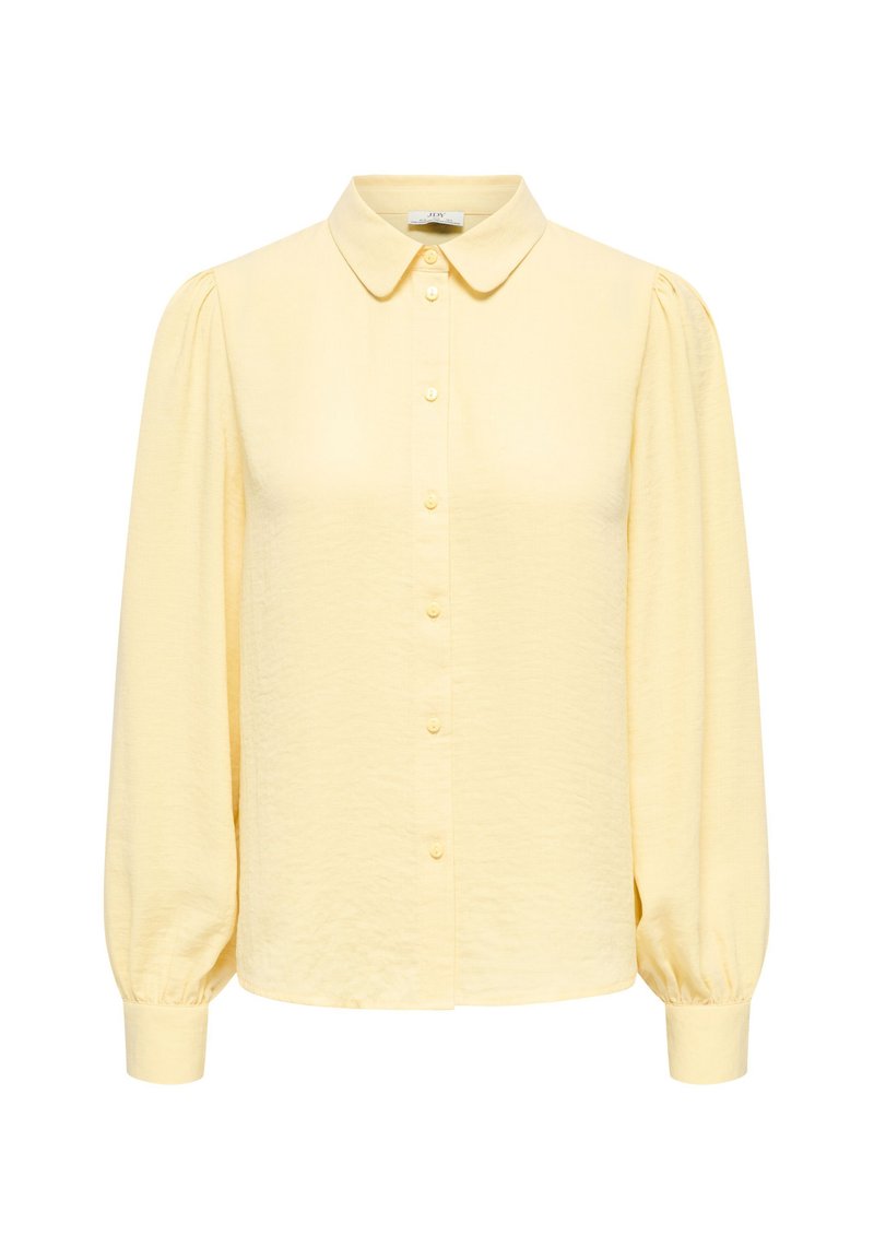 Κίτρινο πουκάμισο με γιακά, μακριά μανίκια με φουσκάλες και απαλή υφή. Διαθέτει εμπρόσθια πατιλέτα με κουμπιά στο ίδιο χρώμα.