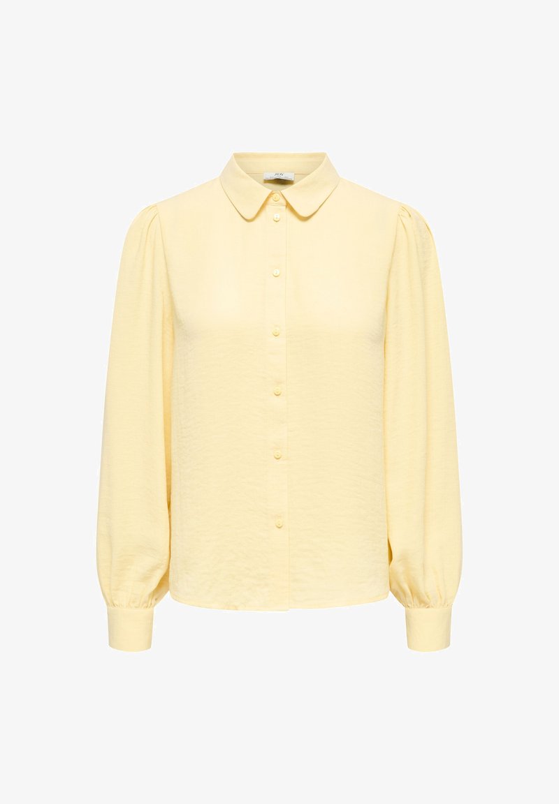 Κίτρινο πουκάμισο με γιακά, μακριά μανίκια με φουσκάλες και απαλή υφή. Διαθέτει εμπρόσθια πατιλέτα με κουμπιά στο ίδιο χρώμα.