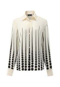 Camicia crema con un motivo a gradiente di puntini neri, bottoni frontali e maniche lunghe con polsini abbottonati. Tessuto liscio e setoso.