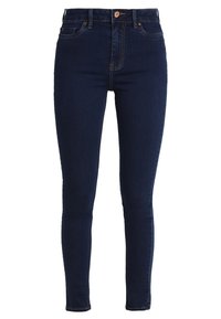 Jeans skinny de mezclilla azul oscuro con cintura alta, que presentan una textura suave, cinco bolsillos y sutiles acentos de costura.