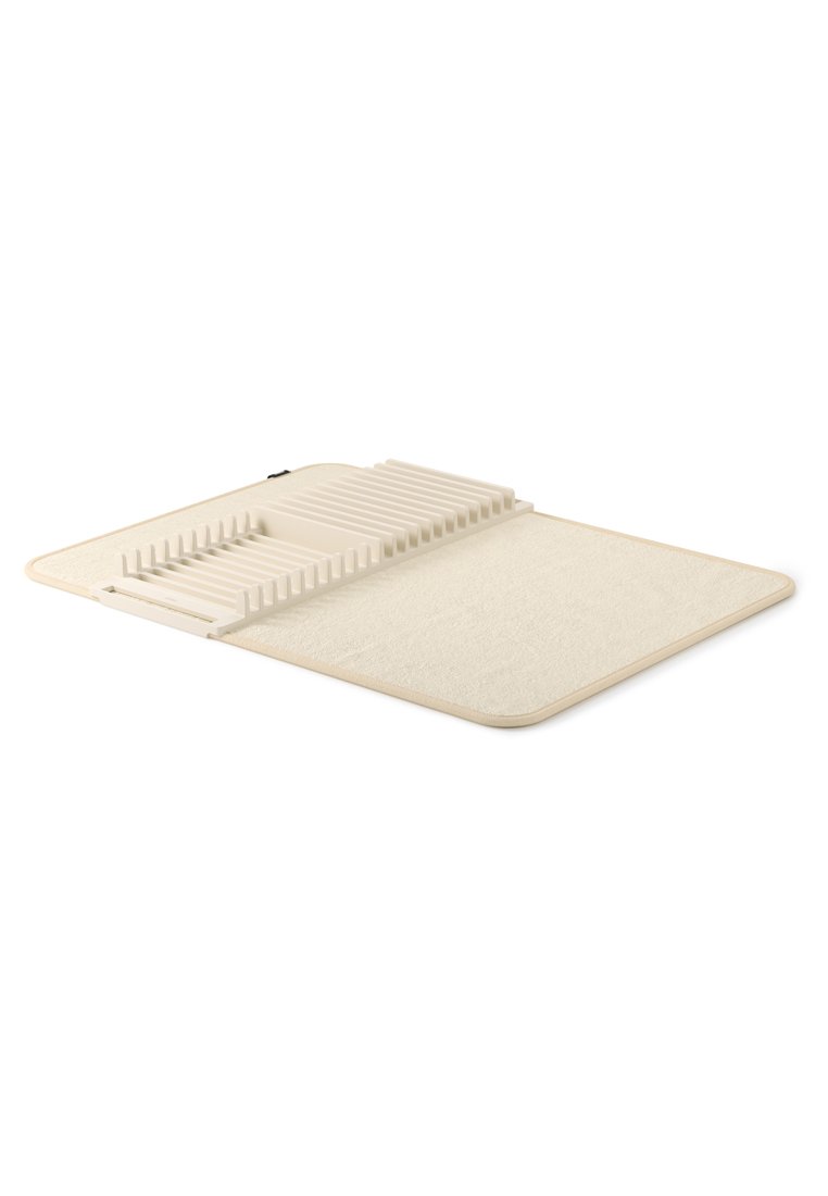 Cremefarbene Filzunterlage mit strukturierter Oberfläche und erhöhten Rillen zur Organisation. Rechteckige Form mit abgerundeten Ecken und minimalistischem Design.