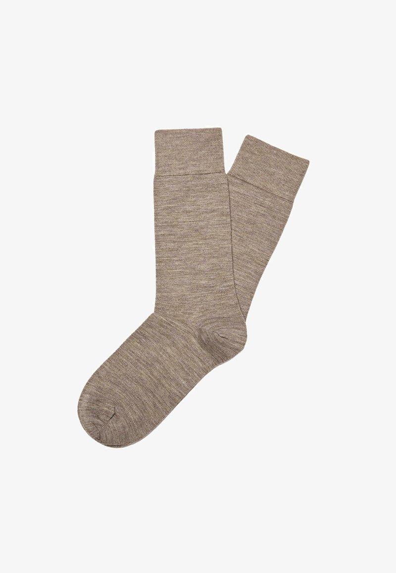 Calze in cotone marrone con una fascia a coste. Il design presenta una consistenza liscia e una lunghezza classica fino al polpaccio, adatte per l'uso quotidiano.