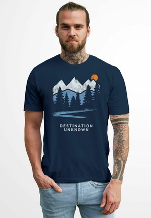 Navy blue t-shirt featuring a mountain and forest graphic in white, blue, and orange, with the text "DESTINATION UNKNOWN" underneath.