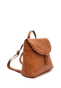 Sac à dos en cuir brun avec un rabat, une fermeture éclair dorée et des accents de pompons. Présente des coutures obliques et des bretelles réglables. Surface texturée.