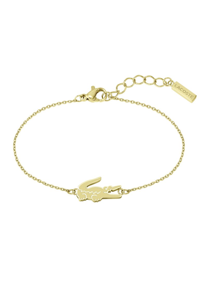 Gold-toned bracelet featuring a crocodile logo charm, linked with a delicate chain and a clasp, including an extender chain with a logo tag.