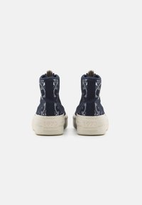 Navy high-top sneakers with patterned accents, textured fabric, and a cream-colored sole featuring the year "1973" on the back.