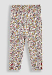 Leggings da ragazza con vita elastica, caratterizzati da una densa stampa floreale multicolore e due bottoni rossi vicino a ciascuna caviglia, su sfondo bianco.
