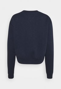 Sweat-shirt bleu marine à manches longues et col rond avec poignets et ourlet côtelés, présenté de dos sur fond blanc.