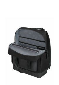 Black backpack with a soft nylon exterior, zipper closure, multiple interior compartments, and a textured base for stability.