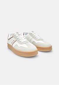 White and light gray sneakers with suede and leather accents, rubber sole, featuring diagonal stripes and textured toe caps.