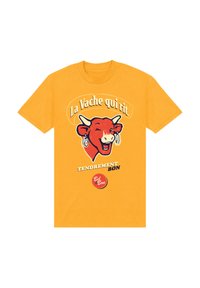 Žluté bavlněné tričko s hravou grafiku červené krávy a textem "La Vache qui rit" a "TENDREMENT BON." Kulatý logo na spodní části.