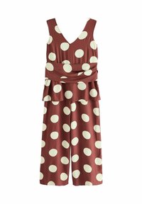 Bordeaux jumpsuit med V-ringning, vid byxdesign, som har stora vita prickar och en lager-pesplummidja. Slät tygtextur.