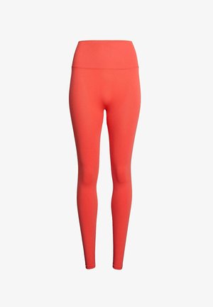 Leggings corallo con vita alta, realizzati in tessuto elasticizzato. Texture liscia, design aderente e senza motivi o accenti visibili.