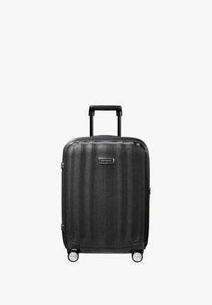 Hard-shell carry-on suitcase in dark gray with textured finish, two wheels, a telescopic handle, and a small brand logo on the front.