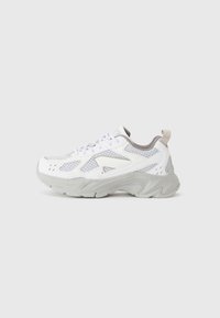White athletic shoe with mesh detailing, grey accents, a chunky sole, and a padded tongue. Curved design with multiple ventilation holes.