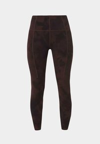 Leggings taille haute de couleur brun foncé avec un motif tie-dye subtil et des coutures visibles en seam verticale sur les jambes et la ceinture.