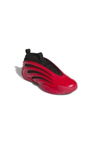 Scarpa sportiva rossa con un design elegante e arrotondato. Presenta una tomaia in rete nera e una suola in gomma testurizzata, caratterizzata da fregi distintivi.