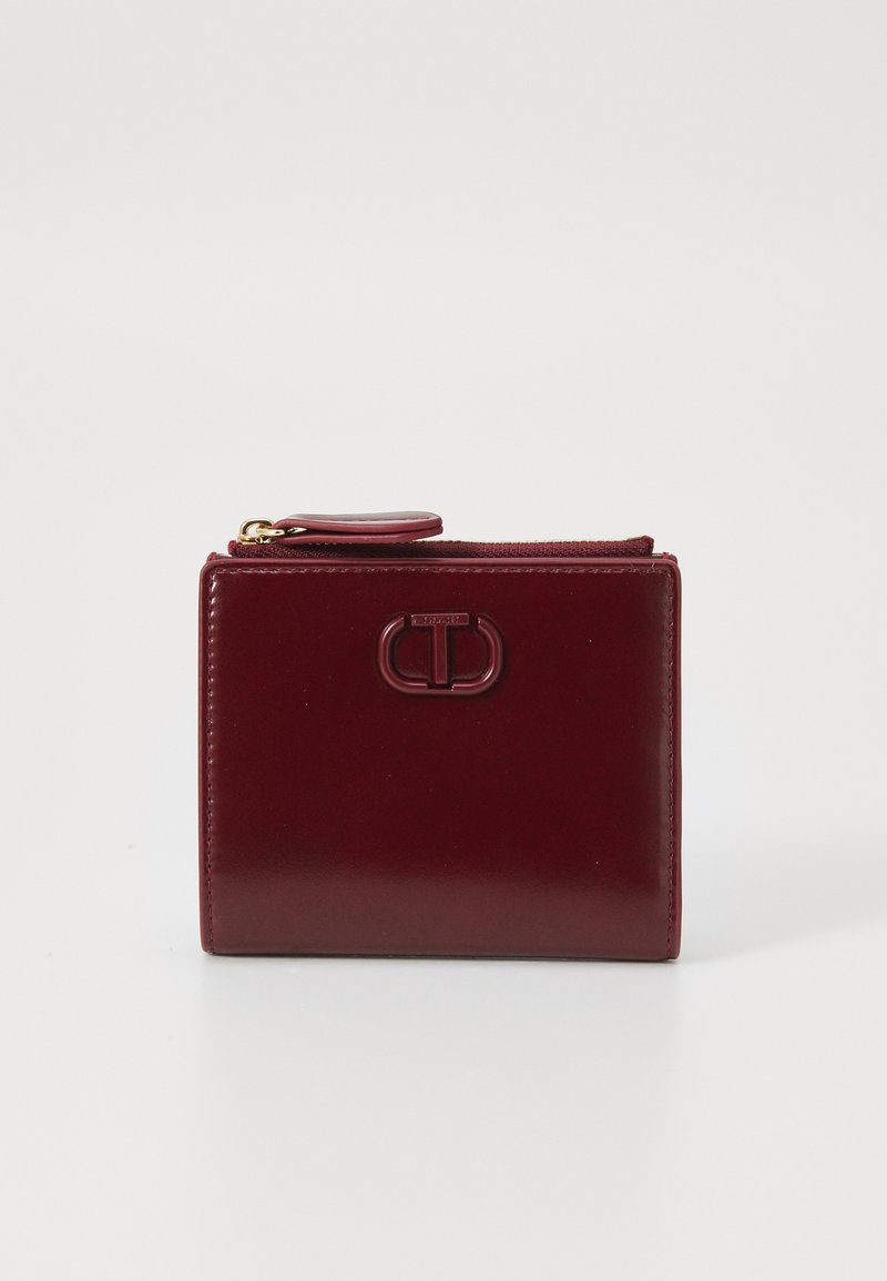 Burgundy leather wallet with a glossy finish, zip closure, and an embossed brand logo on the front. Compact rectangular shape.