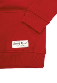 Red sweatshirt with ribbed cuff and hem, front pocket, and a white patch reading "Band of Rascals Finest Organic Kids Clothes."