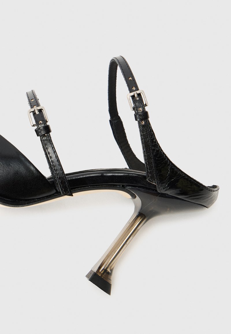 Black high-heeled sandal with open toe, adjustable straps, and a metallic transparent heel. Smooth leather upper with glossy finish.