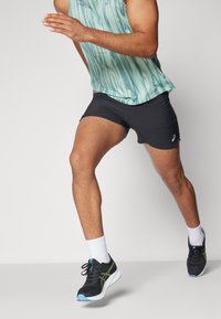 Running shorts in black with a smooth texture, paired with a lightweight mint tank top featuring vertical blue stripes. Black running shoes with green accents.
