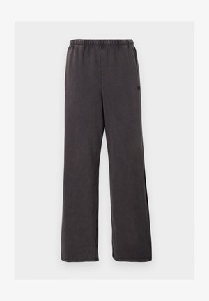 Pantalon de survêtement gris foncé à coupe ample avec taille élastique, jambes droites et poches latérales discrètes visibles sur fond blanc.