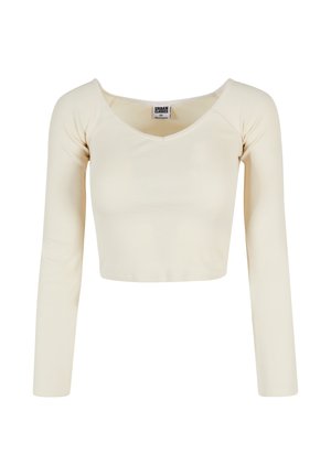 Krémový cropped top s dlouhým rukávem, kulatým výstřihem a žebrovanou texturou, s nášivkou Urban Classics velikosti XS uvnitř límce.