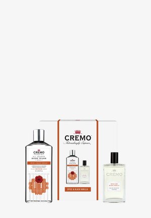 Set Cremo Spice & Black Vanilla avec bouteilles de gel douche et d'eau de toilette affichées à côté d'un emballage de marque assorti.