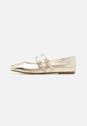 Metallic gold flats with a pointed toe, featuring two adjustable straps across the instep and a flat sole. Smooth texture with a shiny finish.