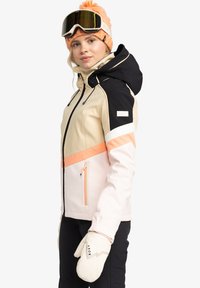 Lyžiarska bunda s farebným blokovaním v béžovej, čiernej a ružovej farbe. Obsahuje predný zips, kapucňu a zipsový vrecko. Súčasťou sú aj biele palčiaky.