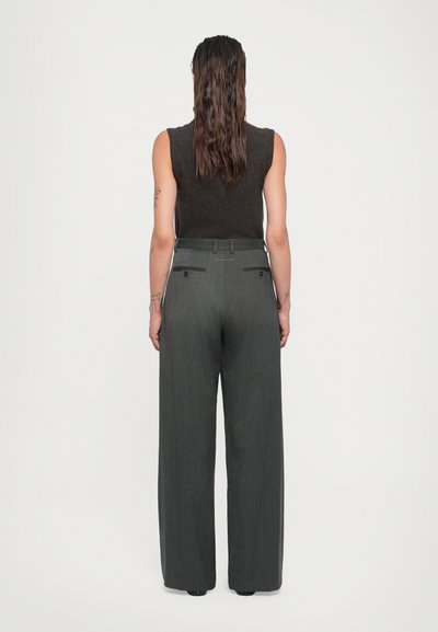Gray wide-leg trousers with a tailored fit, lightweight fabric, and two back pockets. Trousers are paired with a dark sleeveless top.