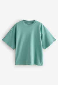 Mint zelena oversized majica izrađena od mekanog pamuka, s okruglim izrezom i kratkim rukavima. Glatka tekstura bez vidljivih uzoraka.