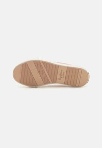 Shoe sole with a textured rubber surface; cream color with light brown accents and a pattern of grooves and ridges for traction.